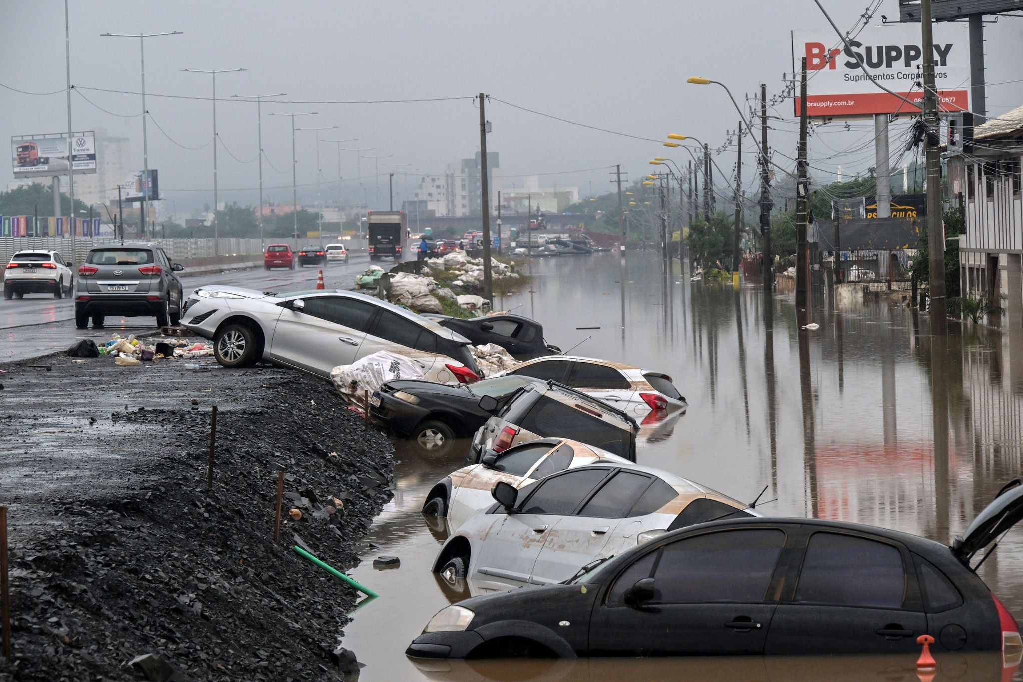 View of stranded cars along the BR-116 road in Sao Leopoldo, Rio Grande do Sul, Brazil, on May 12, 2024. New rains in waterlogged southern Brazil are expected to be heaviest between Sunday and Monday, authorities have warned, bringing fresh misery to victims of flooding that has killed 136 people and left 806 injured and 125 missing so far. (Photo by Nelson ALMEIDA / AFP)